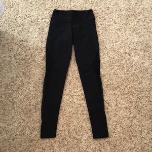 Black athletic leggings with mesh sides